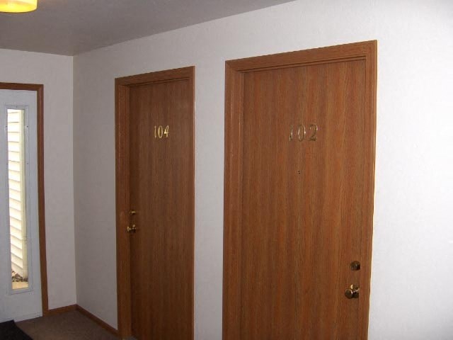 two wooden doors in a room with a window
