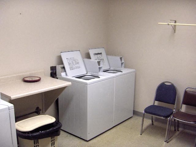 a room with two machines and a table with chairs