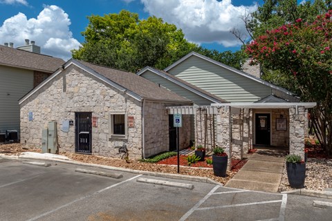 A stone building with a parking sign in front.