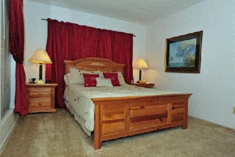 a bedroom with a bed and a red curtain