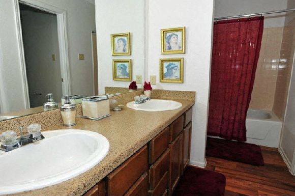 a bathroom with two sinks and a mirror