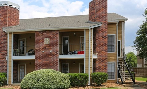 an apartment building with a balcony and a roof