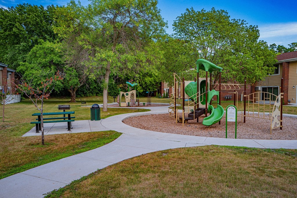 a playground in a park next to a building