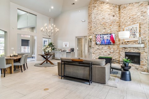 a living room with a couch and a brick fireplace