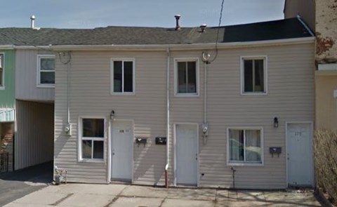 A two-story house with a garage on the ground floor.