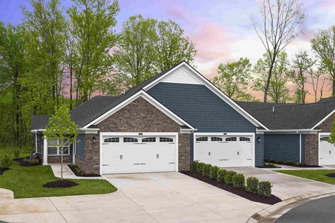 a front view of a house with two garage doors