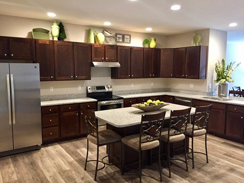 a kitchen with a center island and stainless steel appliances
