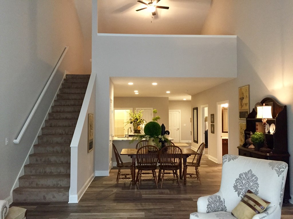 the view from the living room into the dining room and kitchen