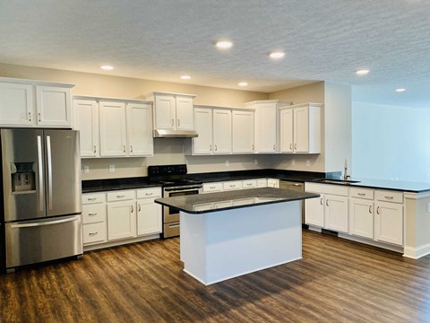 a kitchen with white cabinets and a counter top