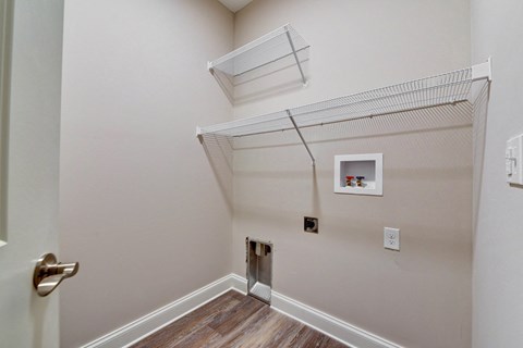 the bedroom has a closet with a wire shelf on the wall and a door to