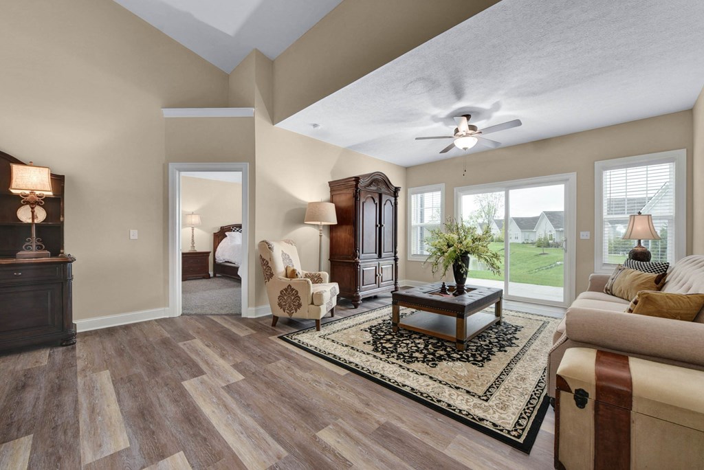 a living room with a ceiling fan and a couch