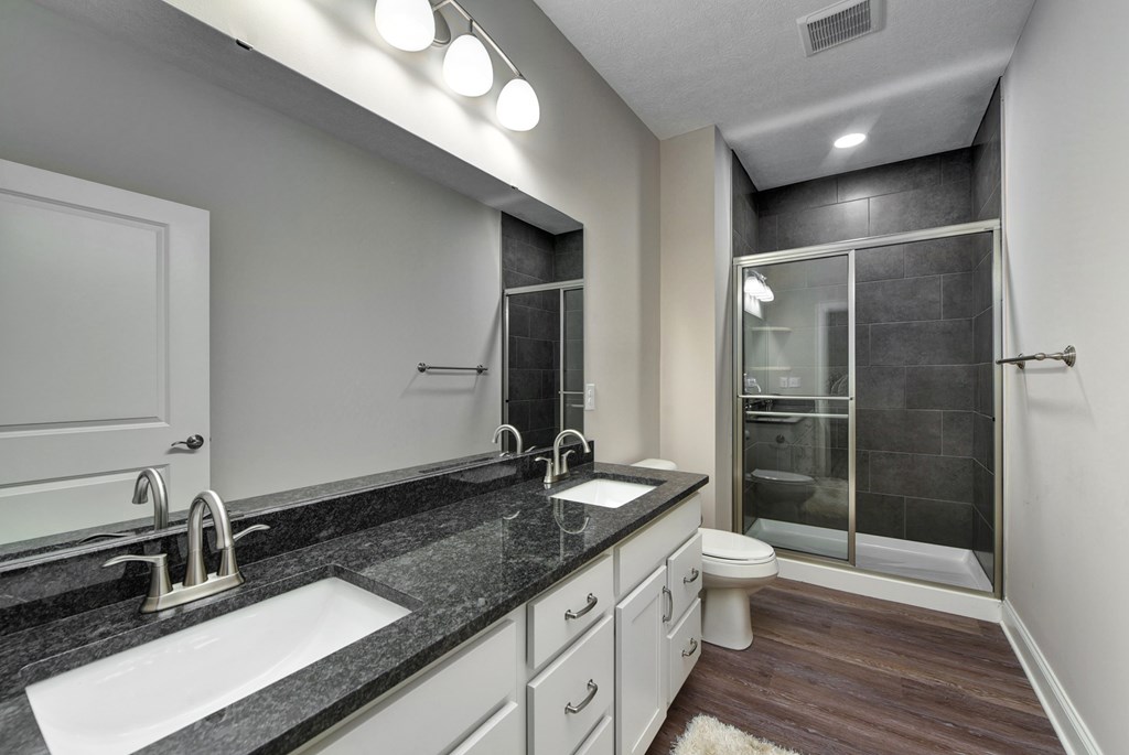 the retreat apartment homes ensuite bathroom with sink and shower