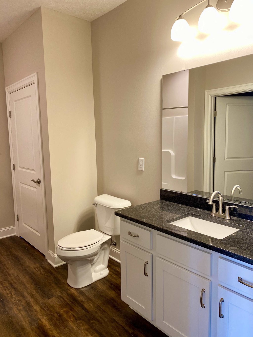 a bathroom with a toilet and a sink and a mirror