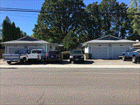 a street scene with cars parked in front of a house