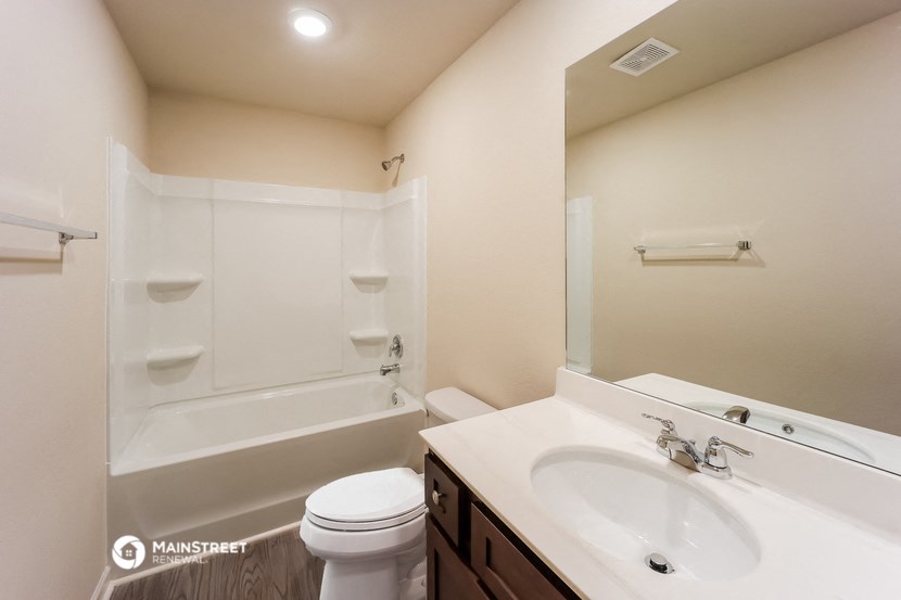 a bathroom with a sink toilet and a bath tub