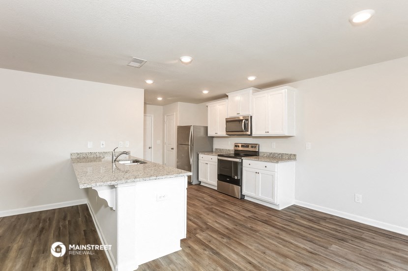 the kitchen of our studio apartment atrium with white cabinets and stainless steel appliances