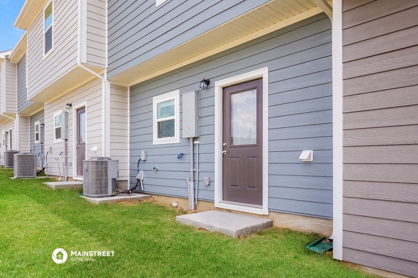the front entrance of a home with a purple door
