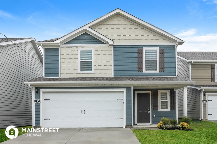 a blue and white house with a garage door