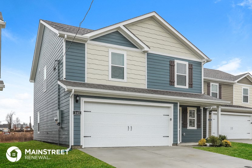 a gray and blue house with a white garage door