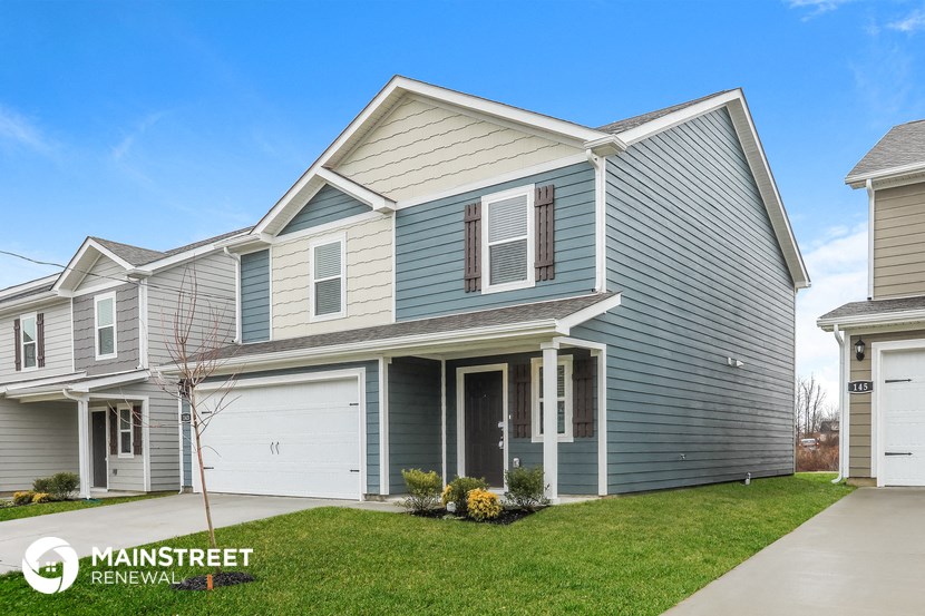 a blue house with a white garage door