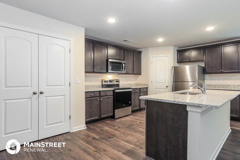the kitchen is updated with stainless steel appliances and granite counter tops