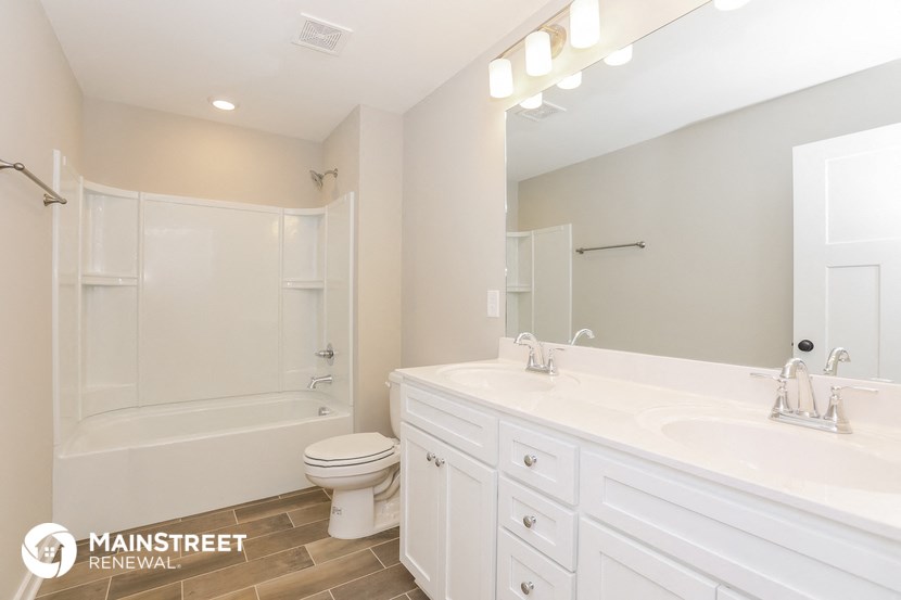a bathroom with a white sink and a shower and a toilet