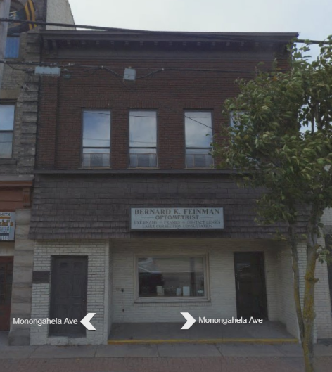 the front of a brick building with two arrows pointing to different directions