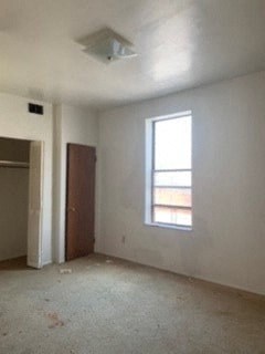 an empty room with a window and a door