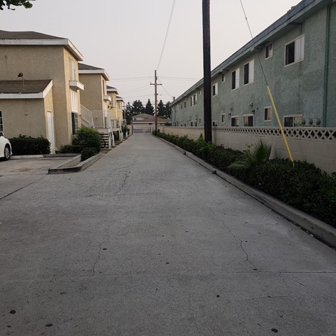 an empty street with houses on both sides of it