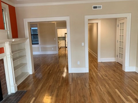 a living room and dining room with a hard wood floor