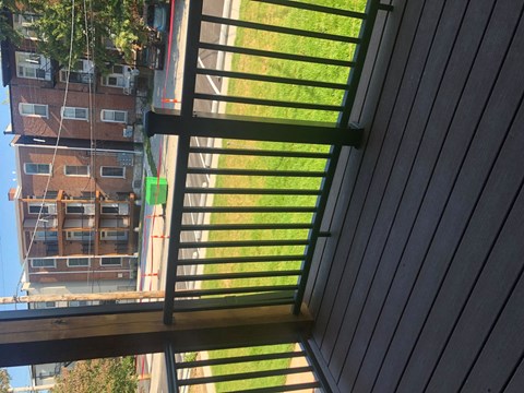 A view from a balcony looking down at a building.