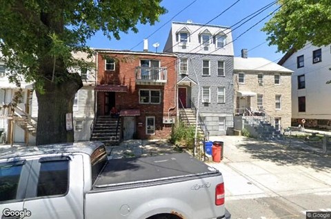 a white truck parked in front of an old house