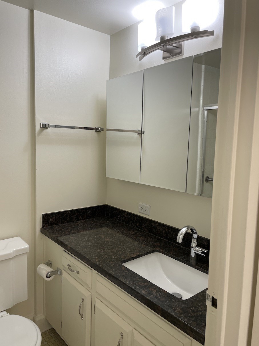 a small bathroom with a sink and a mirror