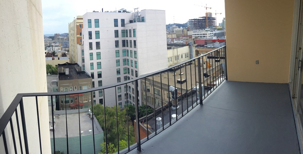 a view of the city from the balcony of a apartment