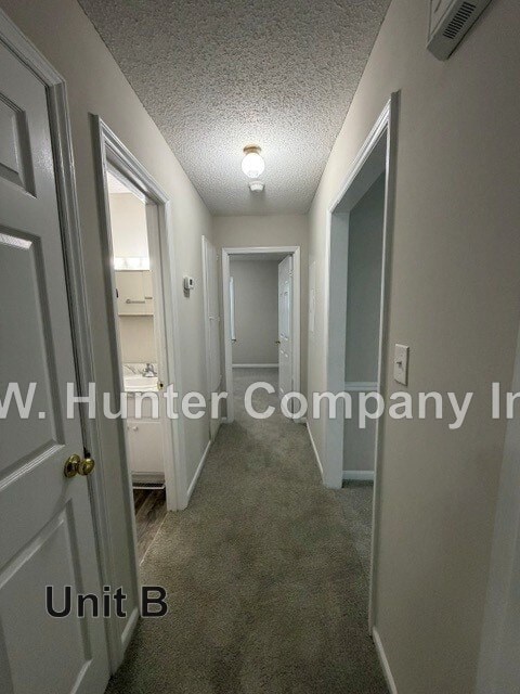 A hallway with the text "W. Hunter Company Inc Unit B" on the bottom.