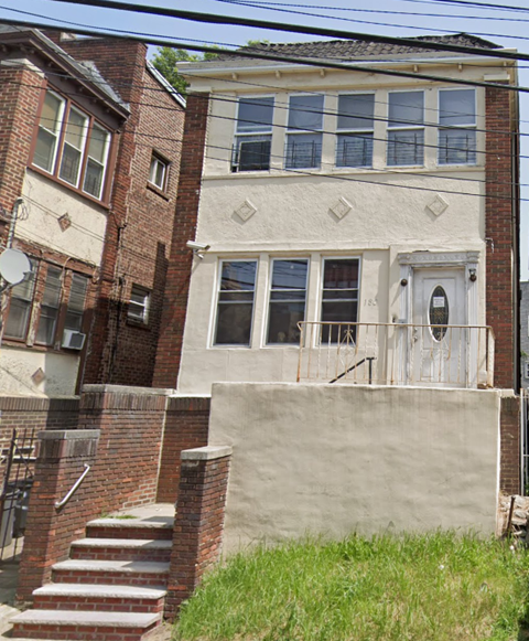 the front of a building with stairs and a ramp