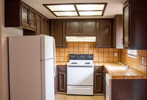 a kitchen with a white stove and a refrigerator