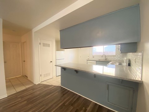 A kitchen area with a counter and a window.