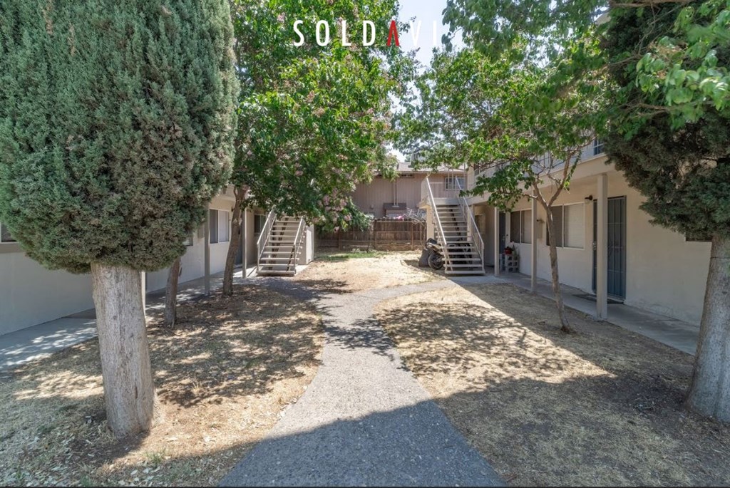 A courtyard with a "SOLD" sign in the middle.