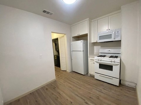 a kitchen with white appliances and a white refrigerator
