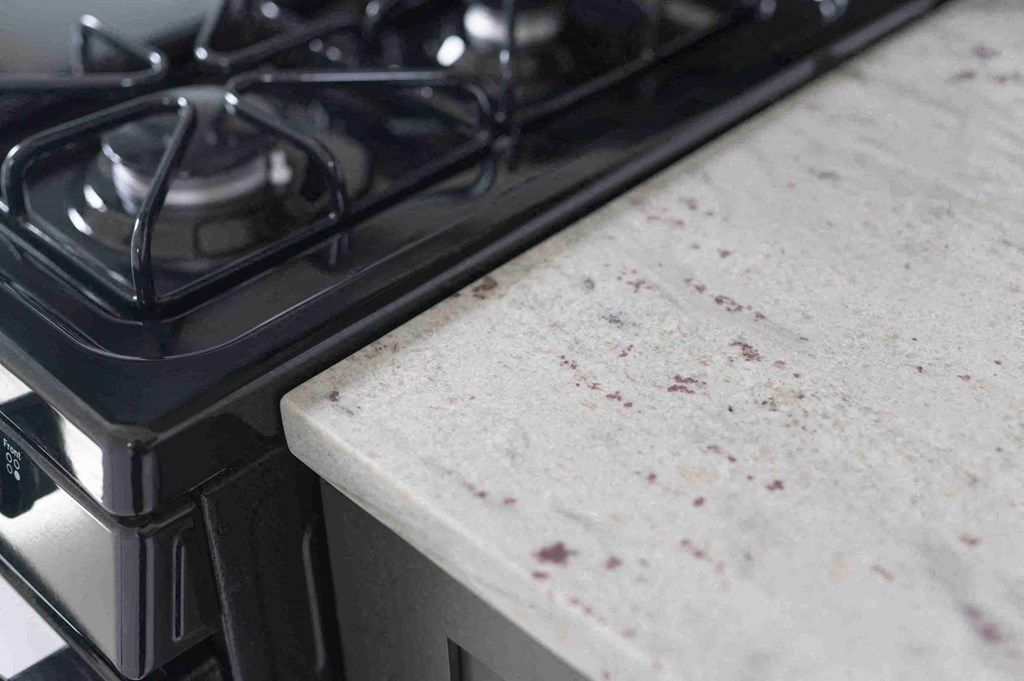 a kitchen counter covered in blood next to a stove