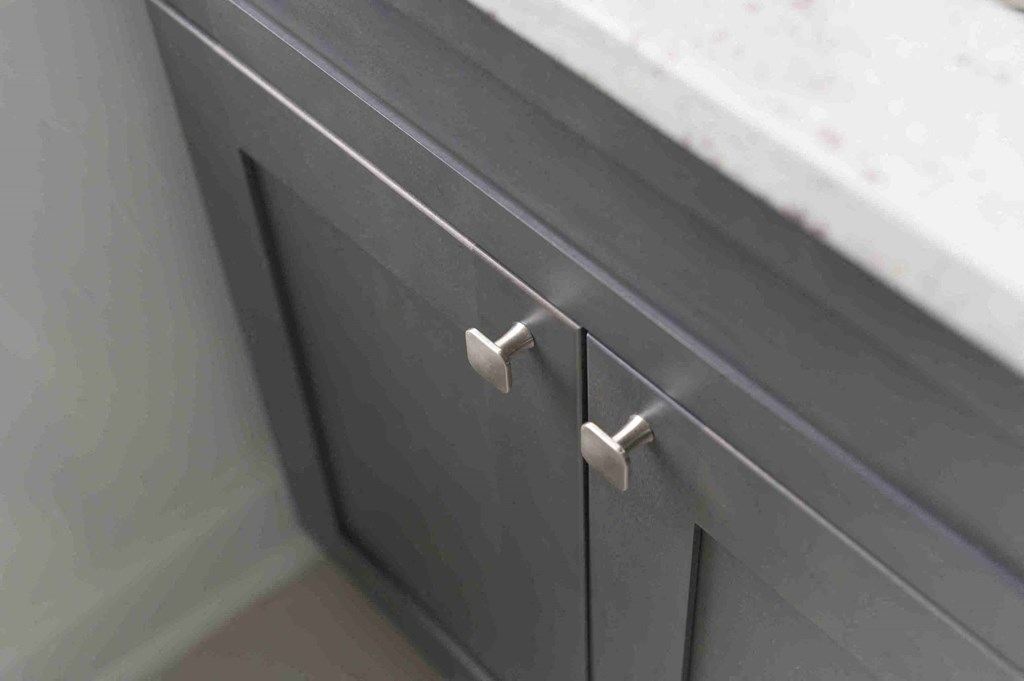 a close up of the drawers of a grey cabinet
