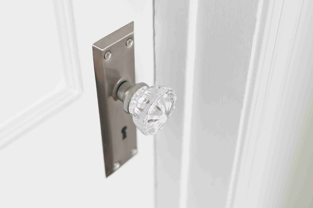 a glass door knob on a white door