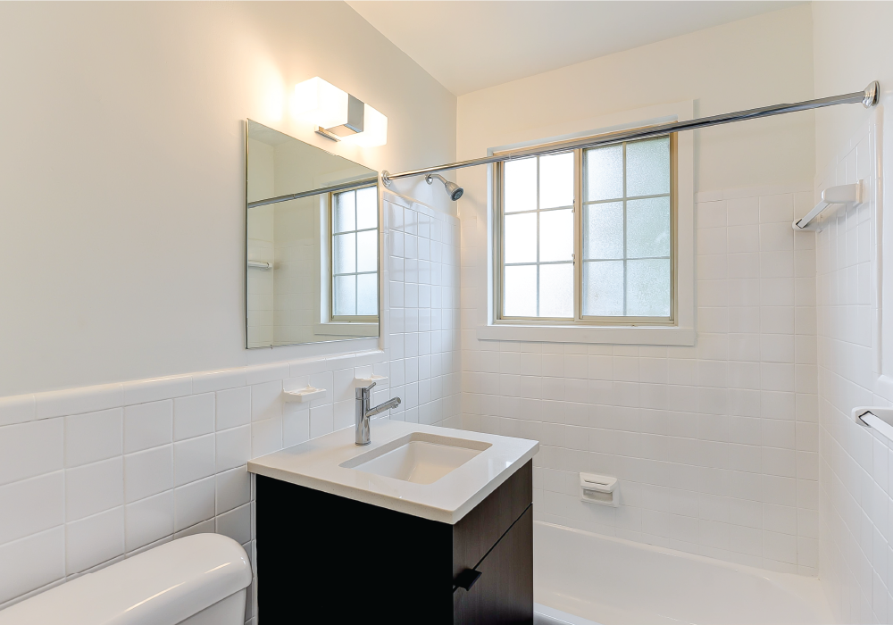 a white bathroom with a sink and a mirror