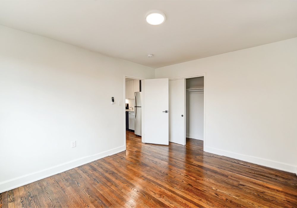 a living room with wood floors and white walls