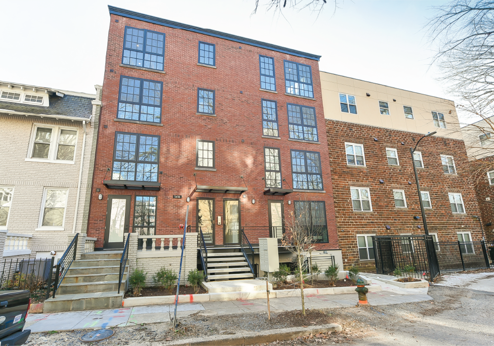 a red brick building with stairs in front of it