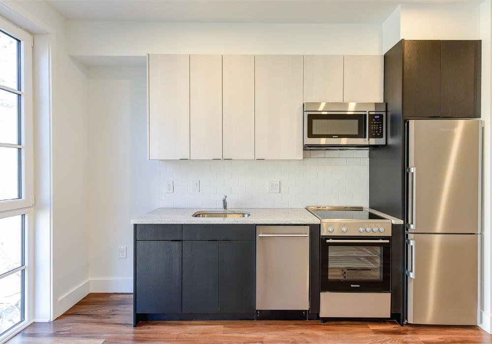 a kitchen with stainless steel appliances and white cabinets