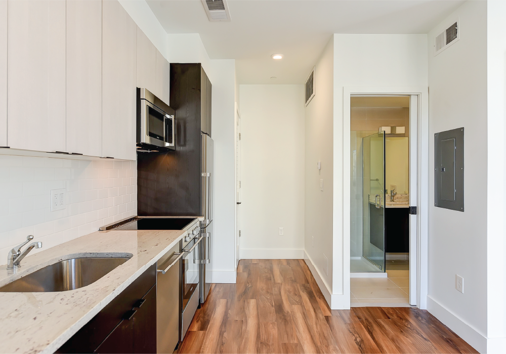 a kitchen with stainless steel appliances and white cabinets