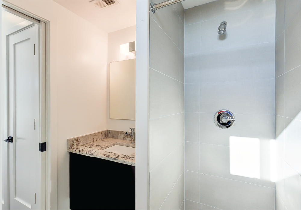 a small bathroom with a sink and a shower