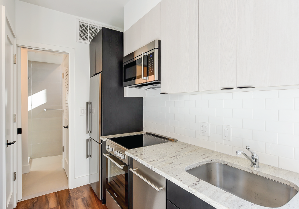an empty kitchen with a sink and a microwave